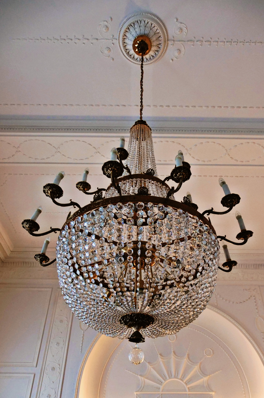 Crystal chandelier in ornate ceiling